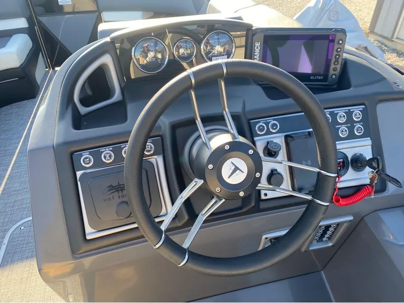 Slide: The Image of 2024 Trifecta 23 RFS 3.0 boat dashboard with steering wheel and control panel. - 23