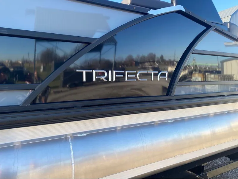 Slide: The Image of 2024 Trifecta 23 RFS 3.0 pontoon boat with sleek black exterior design. - 34
