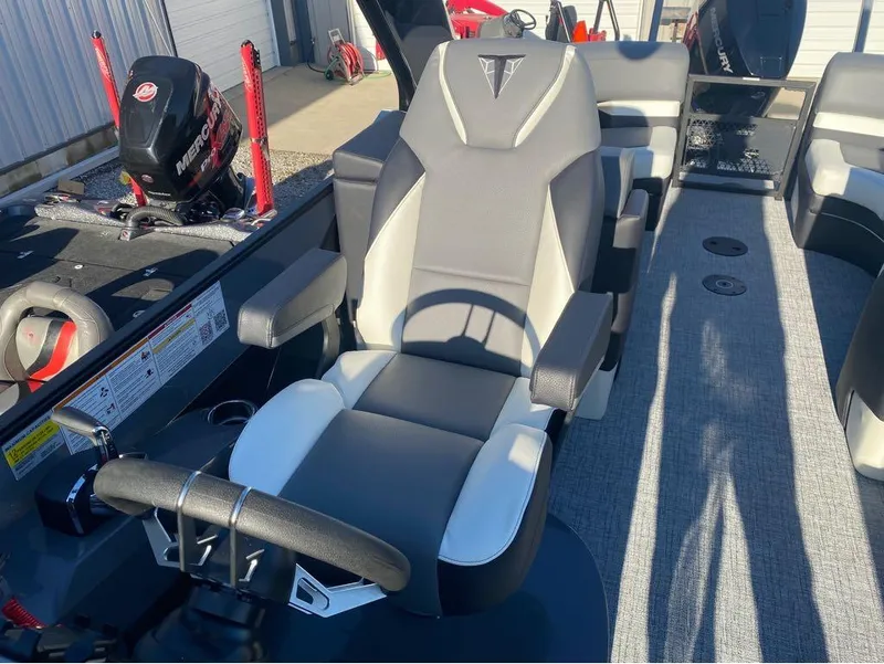 Slide: The Image of 2024 Trifecta 23 RFS 3.0 boat interior with steering wheel and seating. - 7