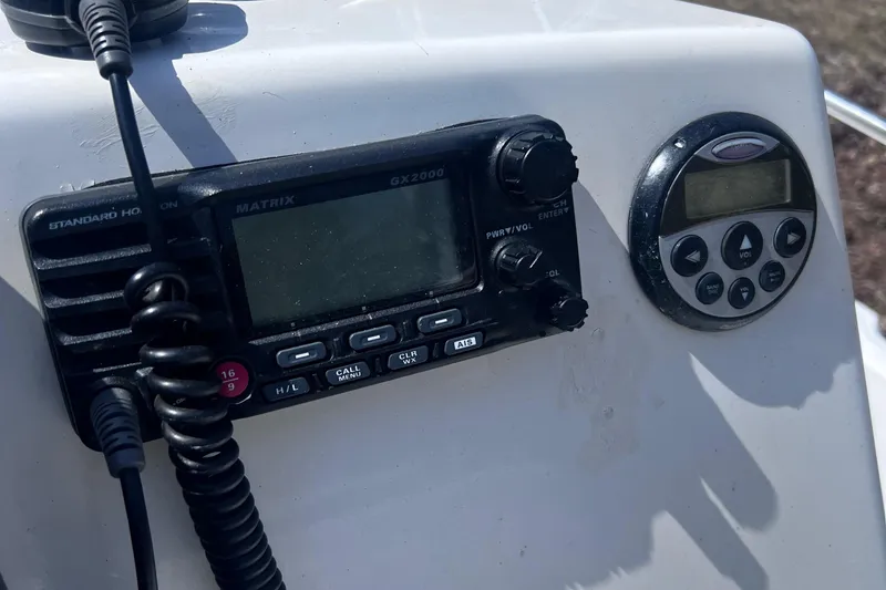 Slide: The Image of Control panel of a 2009 Boston Whaler 200 Dauntless boat with radio and gauges. - 11