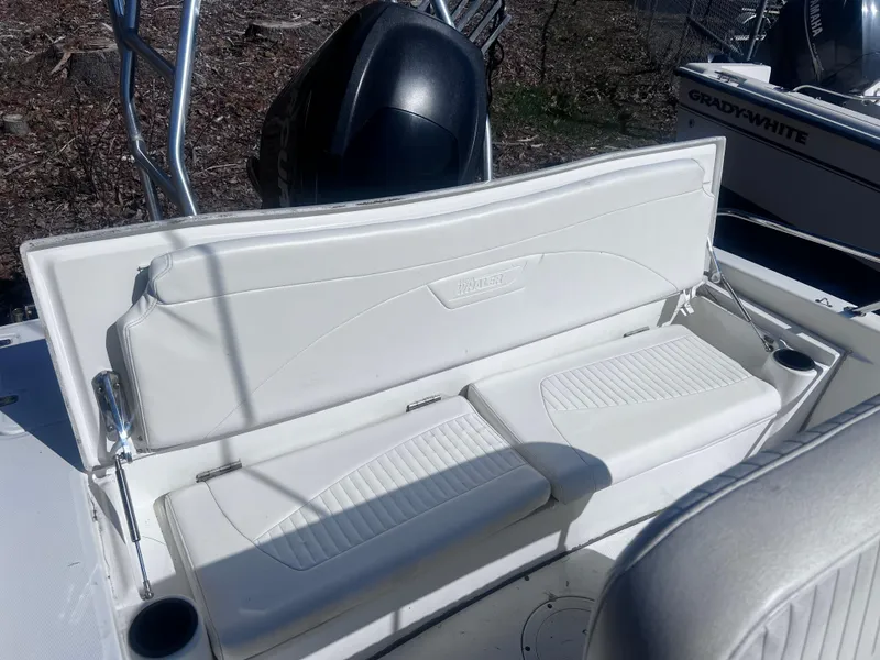 Slide: The Image of 2009 Boston Whaler 200 Dauntless boat seat with white upholstery and cup holder. - 14