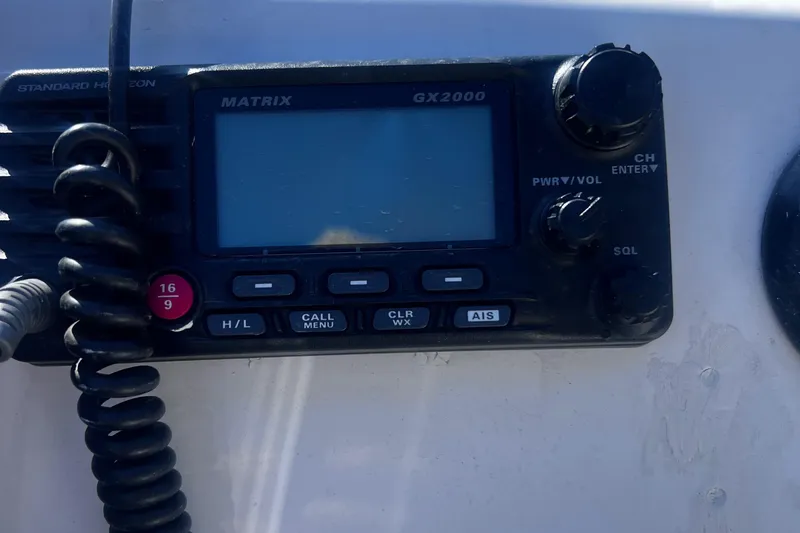 Slide: The Image of VHF radio on a 2009 Boston Whaler 200 Dauntless boat dashboard. - 17