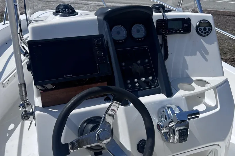 Slide: The Image of 2009 Boston Whaler 200 Dauntless boat dashboard with steering wheel and navigation instruments. - 9