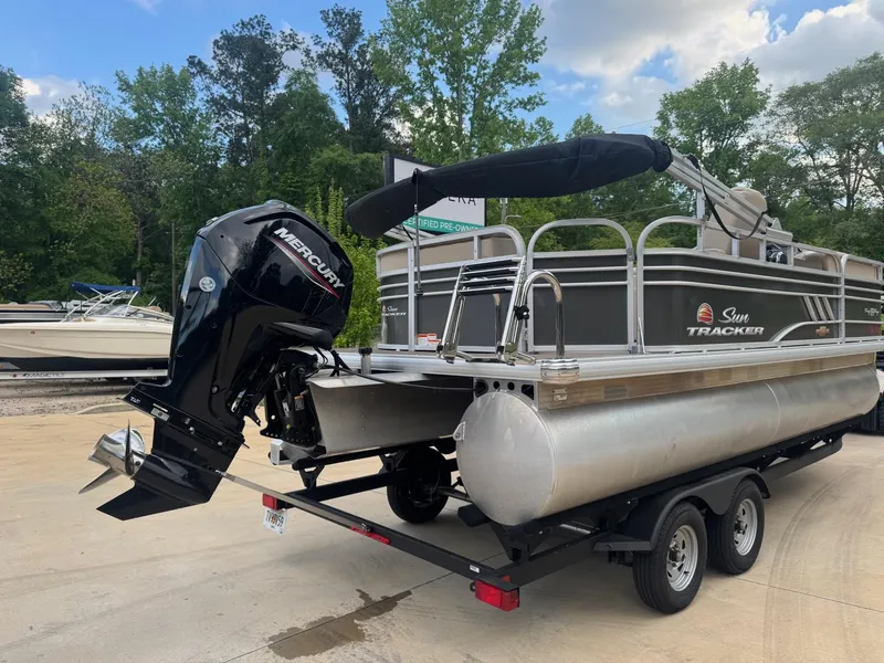 Slide: The Image of 2023 Sun Tracker Party Barge 20 DLX pontoon boat on trailer, with Mercury outboard motor. - 3