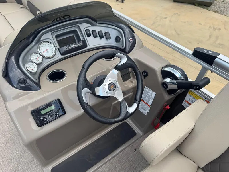 Slide: The Image of 2023 Sun Tracker Party Barge 20 DLX dashboard with steering wheel and controls. - 8
