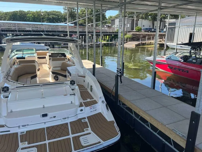 Slide: The Image of 2023 Sea Ray SLX 350 docked, featuring spacious seating and modern design. - 1