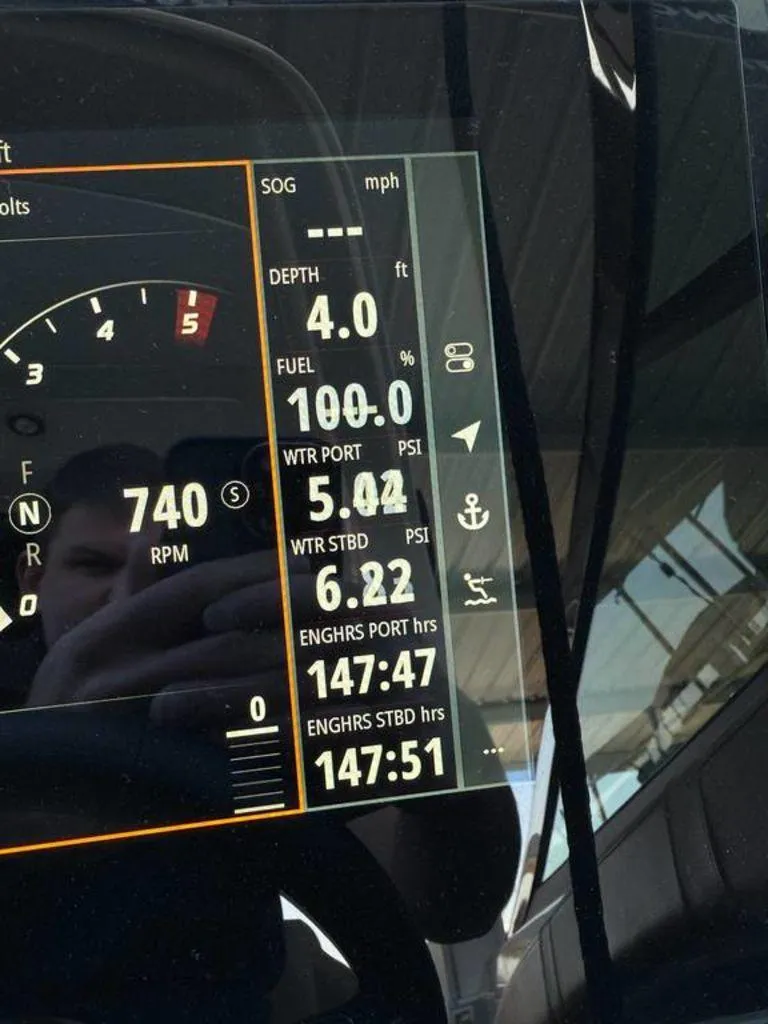 Slide: The Image of Dashboard display of a 2023 Sea Ray SLX 350 boat showing fuel and engine data. - 7
