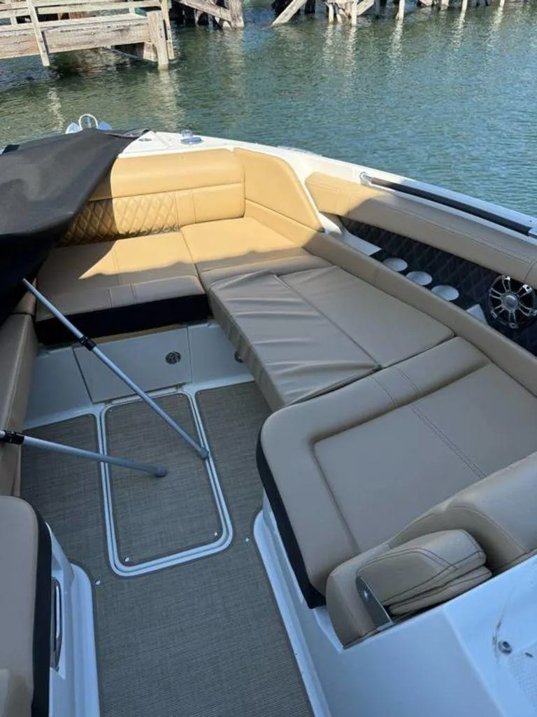 Slide: The Image of 2023 Sea Ray SLX 350 boat interior with tan seating and water view. - 8