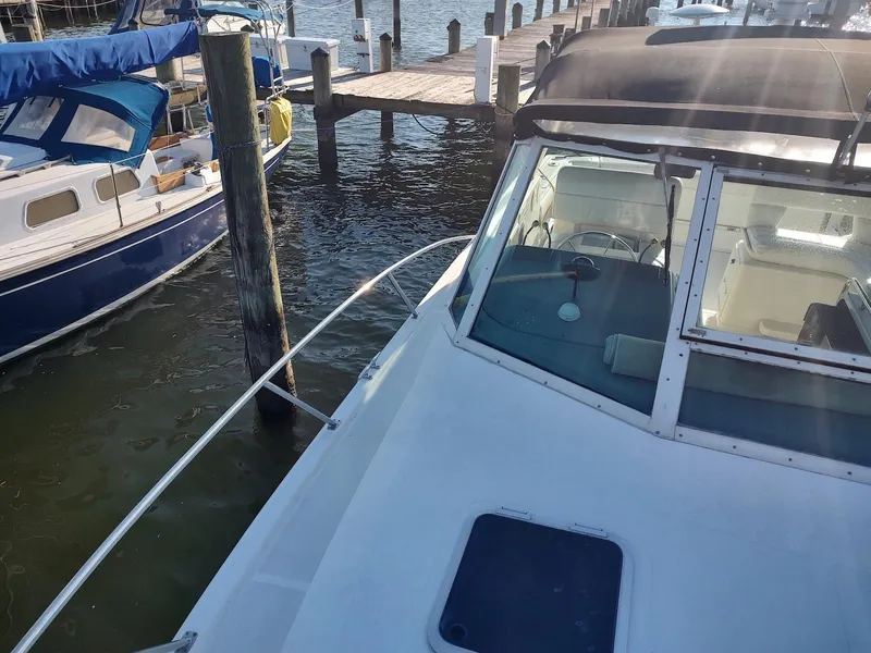 Slide: The Image of 1994 Tiara Yachts 3100 Open docked at marina, sunny day, calm waters. - 12