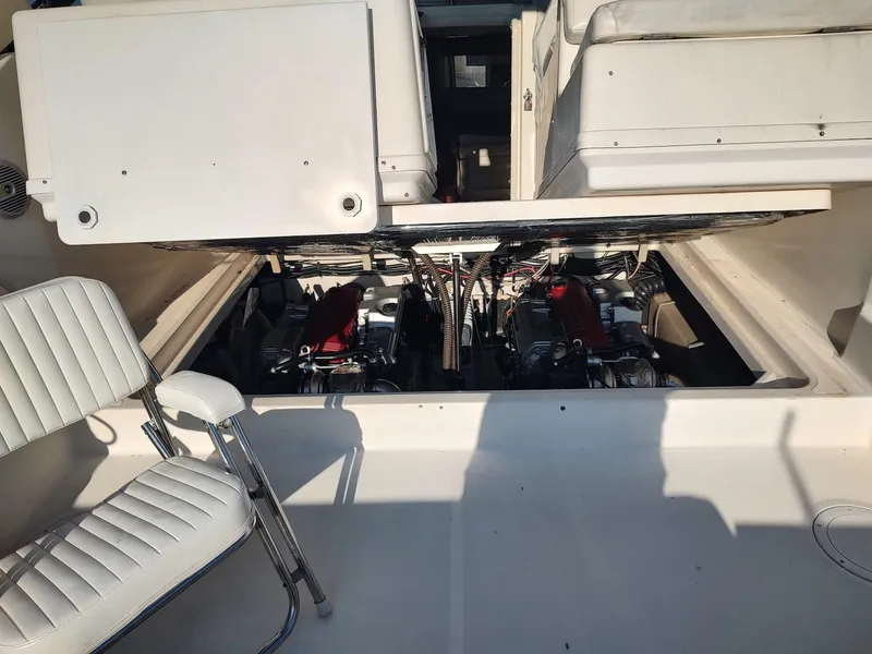 Slide: The Image of 1994 Tiara Yachts 3100 Open engine compartment with visible seating and mechanical components. - 14