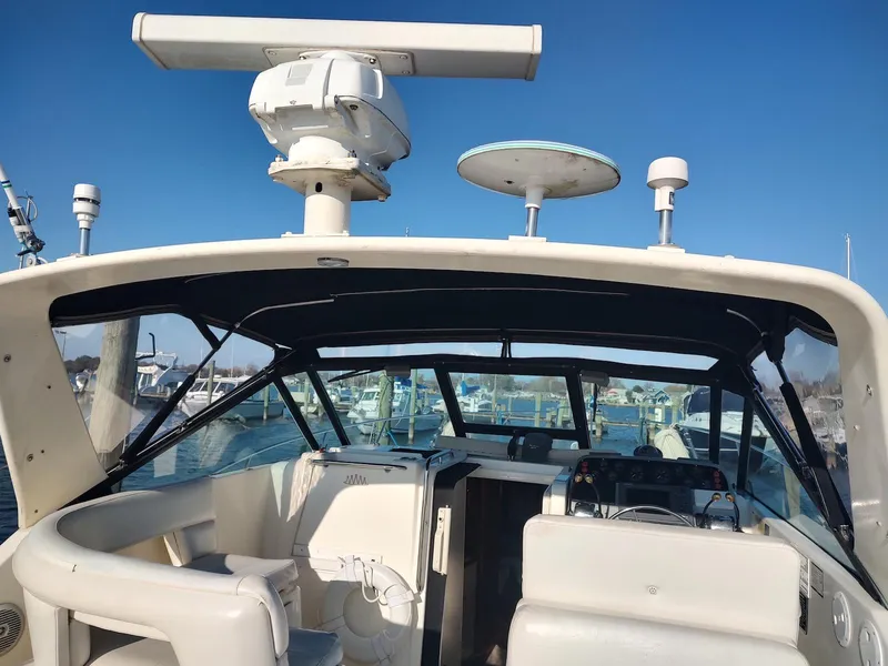 Slide: The Image of 1994 Tiara Yachts 3100 Open boat interior with radar equipment, docked in a marina. - 15