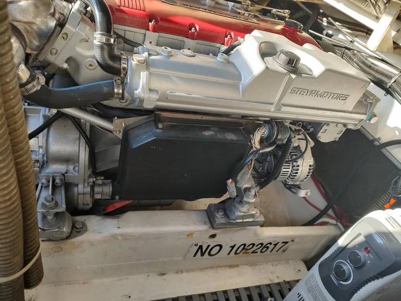 Slide: The Image of Engine compartment of a 1994 Tiara Yachts 3100 Open, showcasing mechanical components and serial number. - 18