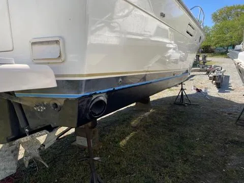 Slide: The Image of 1994 Tiara Yachts 3100 Open on dry dock, showing hull and propeller area. - 19