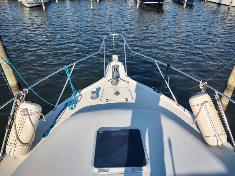 Slide: The Image of Bow view of 1994 Tiara Yachts 3100 Open, docked with fenders and ropes. - 3