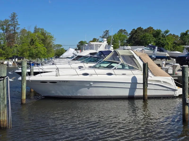 Slide: The Image of 2002 Sea Ray 340 Sundancer docked in a marina on a sunny day. - 0