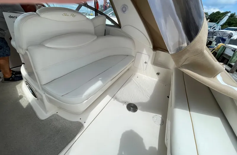 Slide: The Image of 2002 Sea Ray 340 Sundancer interior with white seating and beige accents. - 11