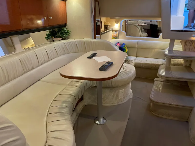 Slide: The Image of Interior of 2002 Sea Ray 340 Sundancer yacht with plush seating and table. - 17