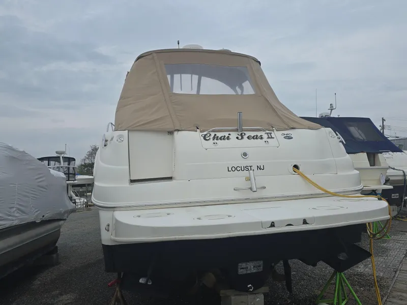 Slide: The Image of 2002 Sea Ray 340 Sundancer boat docked, covered with beige canopy, Locust, NJ. - 6