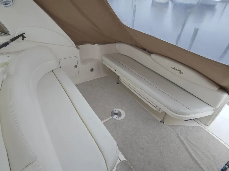 Slide: The Image of 2002 Sea Ray 340 Sundancer interior with beige seating and carpeted floor. - 7