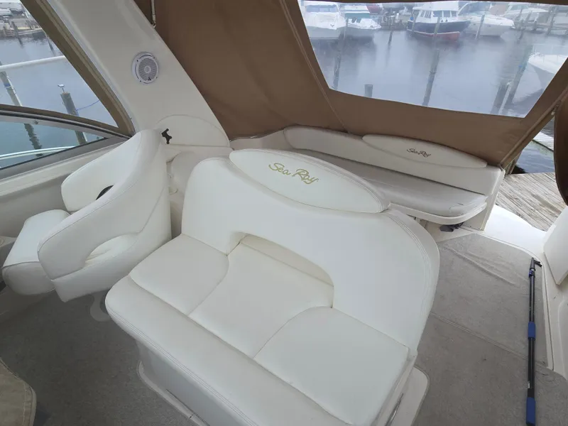Slide: The Image of Interior of 2002 Sea Ray 340 Sundancer with white seating and marina view. - 8