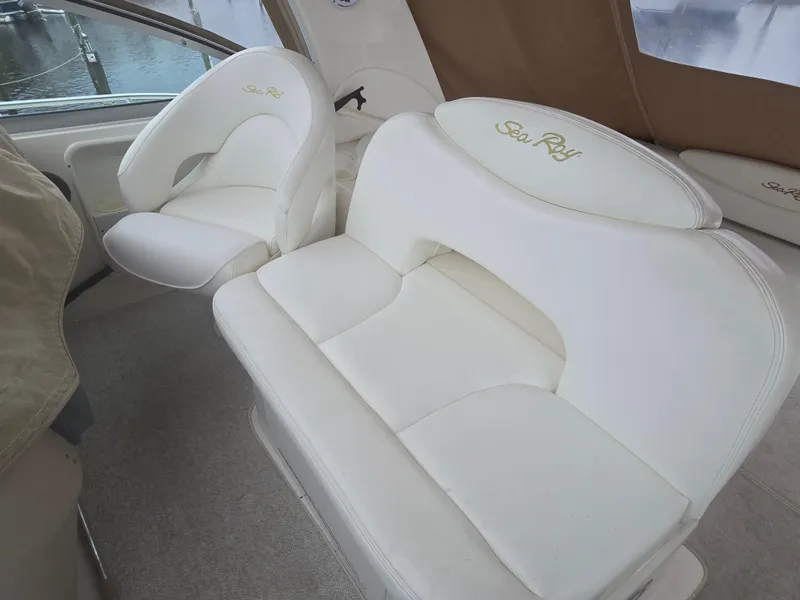 Slide: The Image of 2002 Sea Ray 340 Sundancer interior with white leather seating and embroidered logos. - 9
