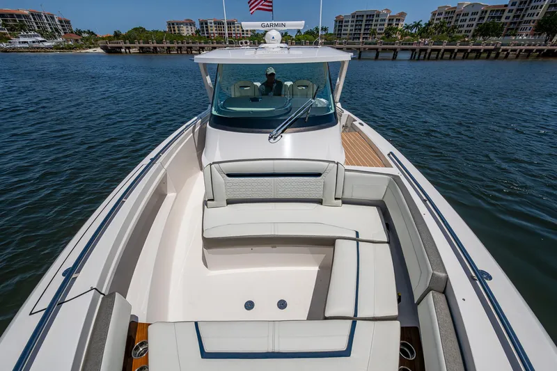 Slide: The Image of 2024 Tiara Yachts 38 LS luxury boat on calm water, featuring spacious seating and sleek design. - 15