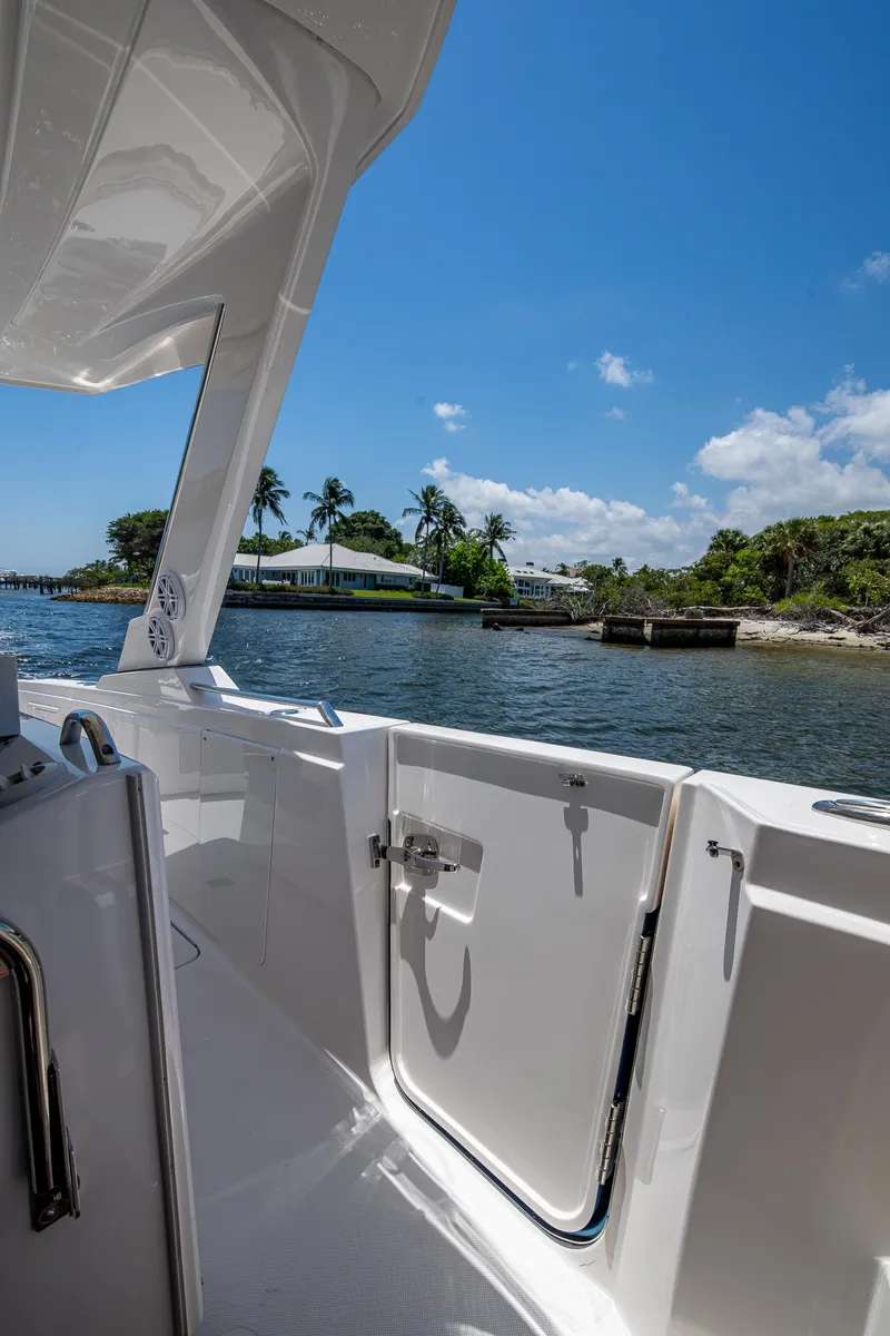 Slide: The Image of 2024 Tiara Yachts 38 LS, docked with scenic waterfront view under clear blue sky. - 18