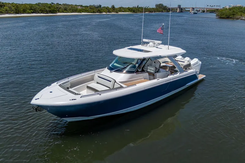 Slide: The Image of 2024 Tiara Yachts 38 LS cruising on a serene waterway, showcasing sleek design and luxury. - 2