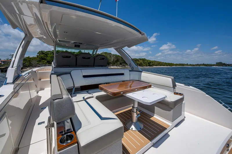 Slide: The Image of 2024 Tiara Yachts 38 LS luxury boat interior with seating and table, on a sunny day. - 28