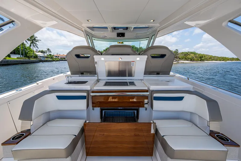 Slide: The Image of 2024 Tiara Yachts 38 LS interior with seating and outdoor kitchen on a sunny day. - 30