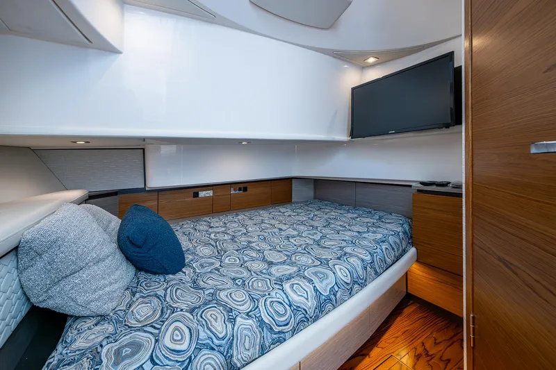 Slide: The Image of 2024 Tiara Yachts 38 LS cabin interior with bed, TV, and modern design. - 32