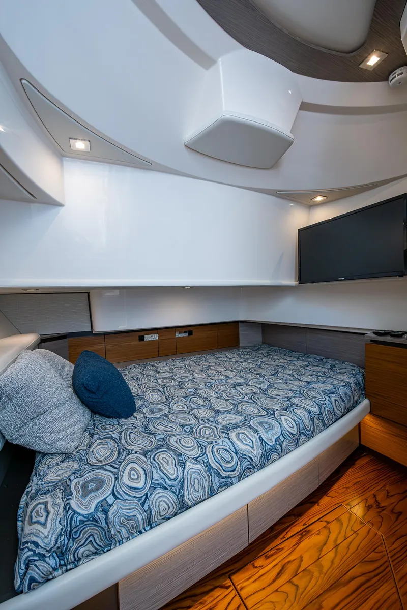 Slide: The Image of 2024 Tiara Yachts 38 LS cabin interior with modern design and cozy bedding. - 33