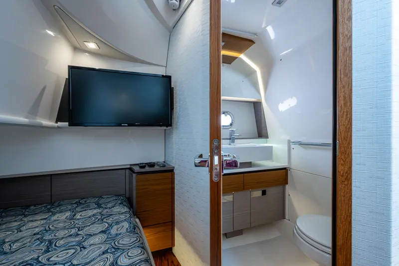 Slide: The Image of 2024 Tiara Yachts 38 LS interior with bed, TV, and modern bathroom. - 34