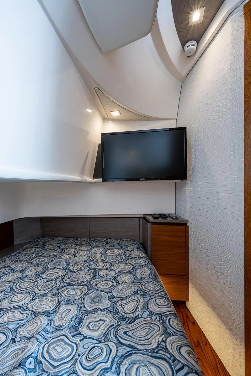 Slide: The Image of 2024 Tiara Yachts 38 LS cabin interior with bed and wall-mounted TV. - 35