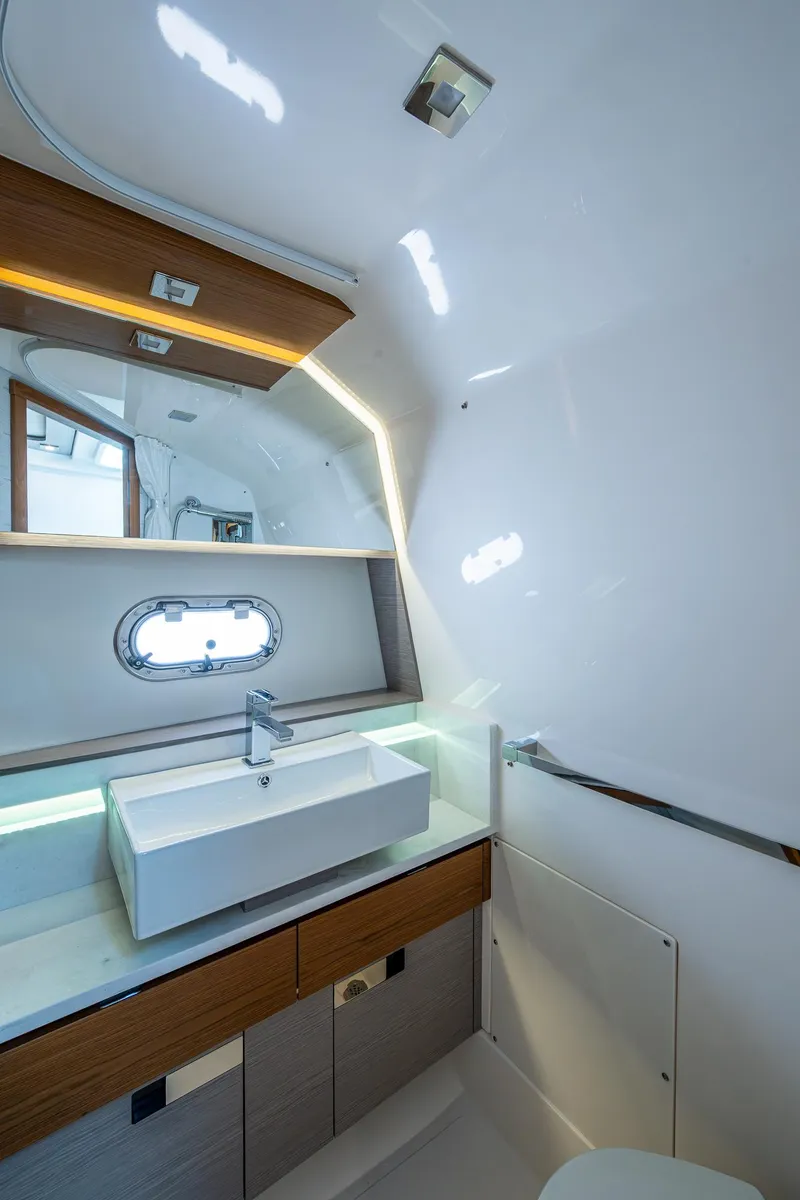 Slide: The Image of 2024 Tiara Yachts 38 LS bathroom with modern sink and mirror design. - 36