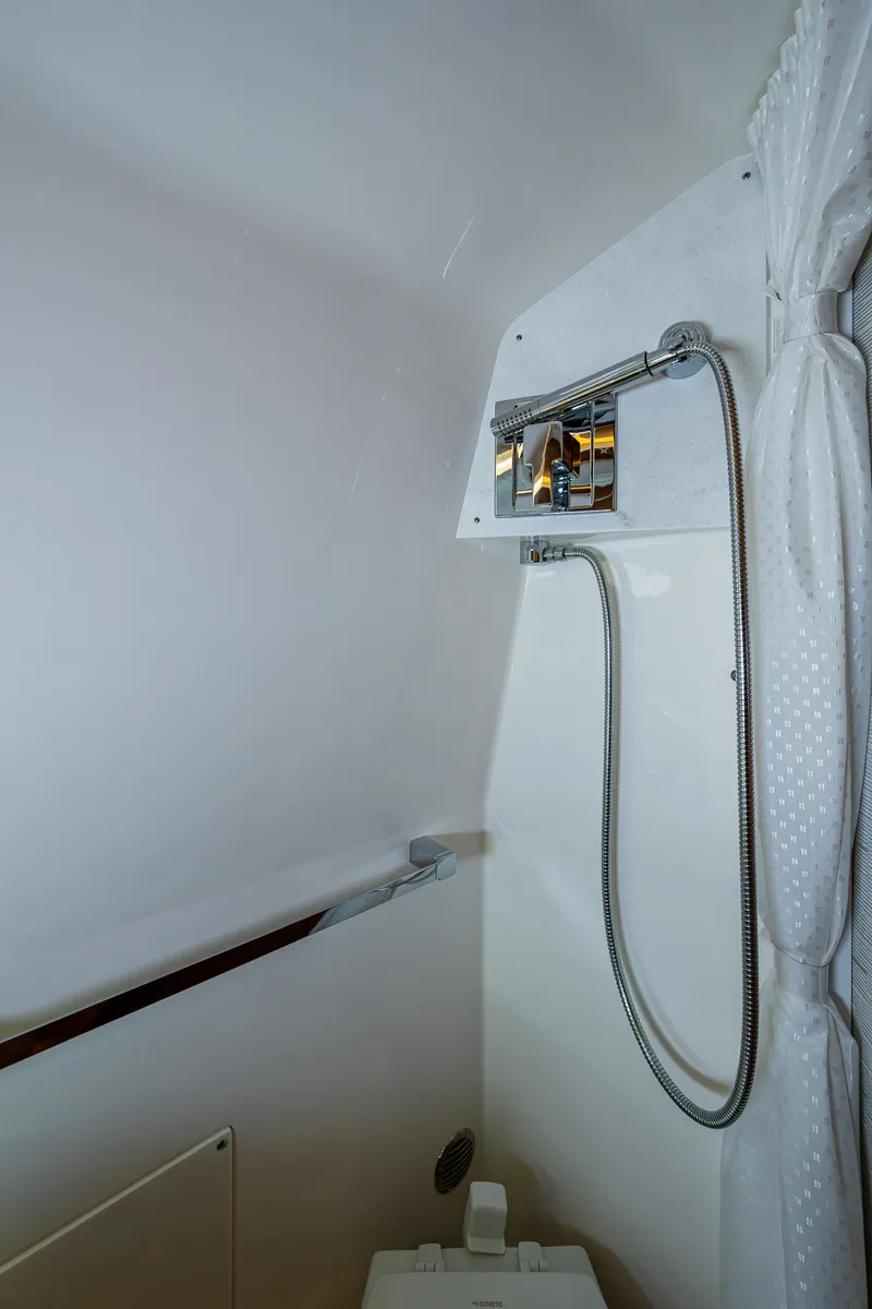 Slide: The Image of 2024 Tiara Yachts 38 LS bathroom with modern shower fixtures and white interior. - 38