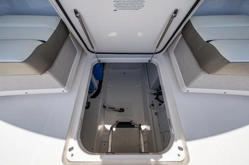Slide: The Image of 2024 Tiara Yachts 38 LS storage compartment with open hatch and cushioned seating. - 40