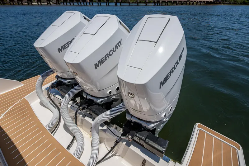 Slide: The Image of Triple Mercury outboard engines on 2024 Tiara Yachts 38 LS, docked on water. - 45