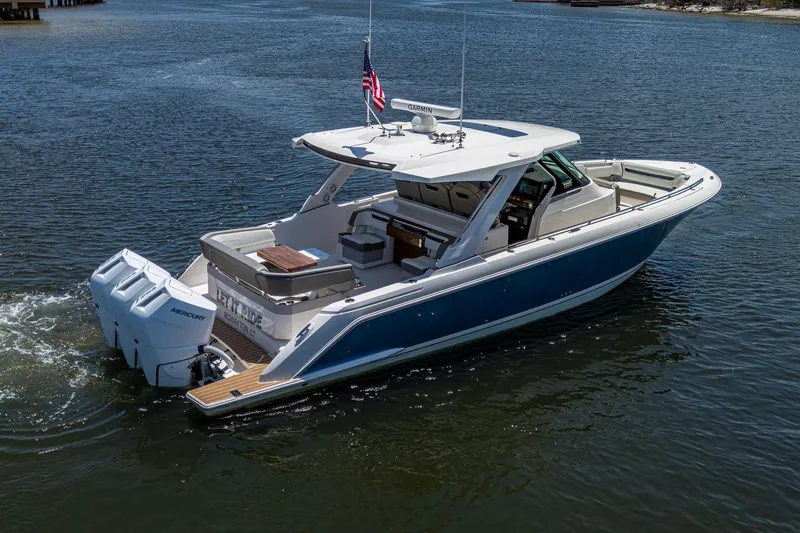 Slide: The Image of 2024 Tiara Yachts 38 LS cruising on calm waters, showcasing sleek design and powerful engines. - 7