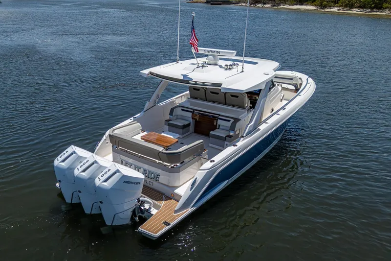 Slide: The Image of 2024 Tiara Yachts 38 LS luxury boat on calm water, rear view. - 8