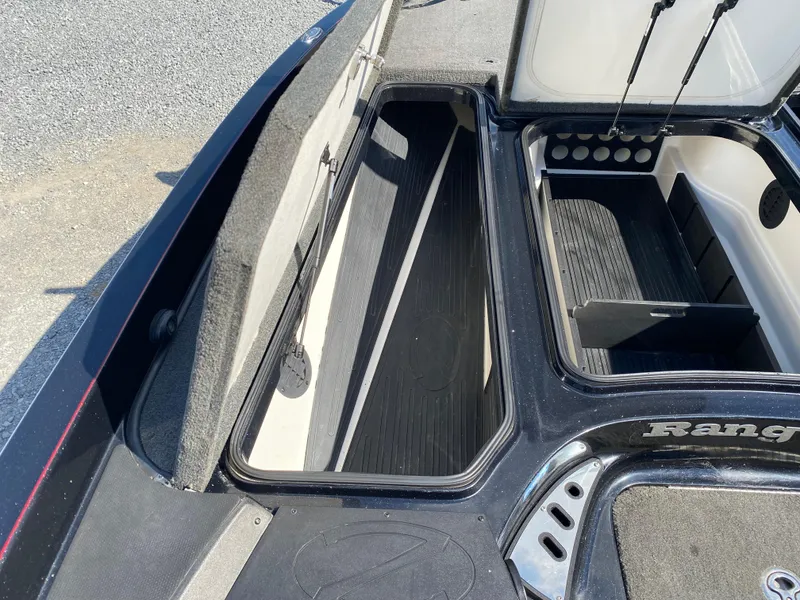 Slide: The Image of 2017 Ranger Z520C Comanche boat storage compartments, open and empty, with black and gray interior. - 17