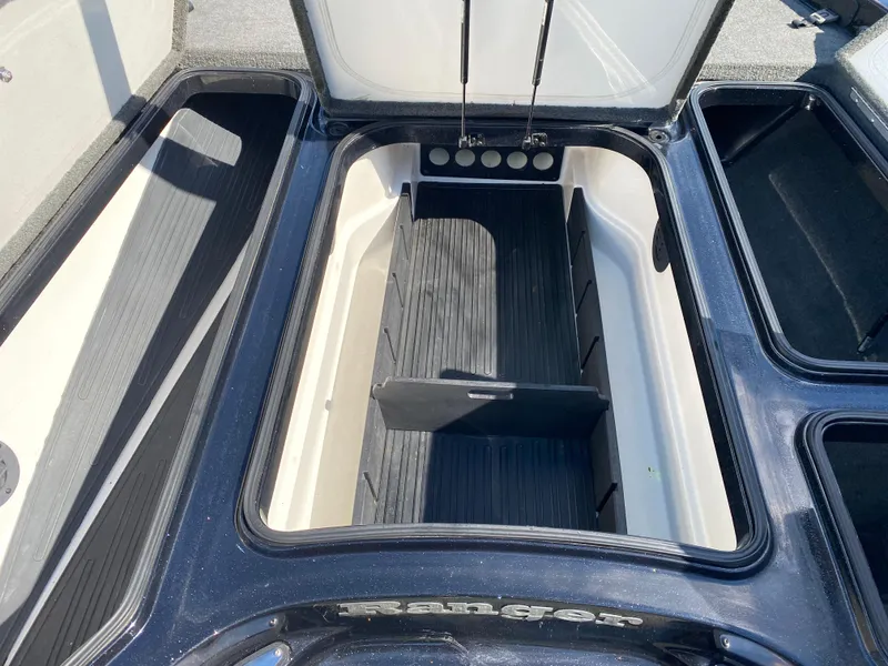 Slide: The Image of 2017 Ranger Z520C Comanche boat storage compartments, open and empty, showcasing interior design. - 18