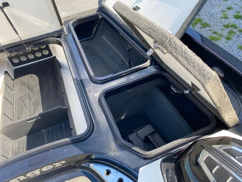 Slide: The Image of 2017 Ranger Z520C Comanche boat storage compartments open, showcasing spacious interior. - 19