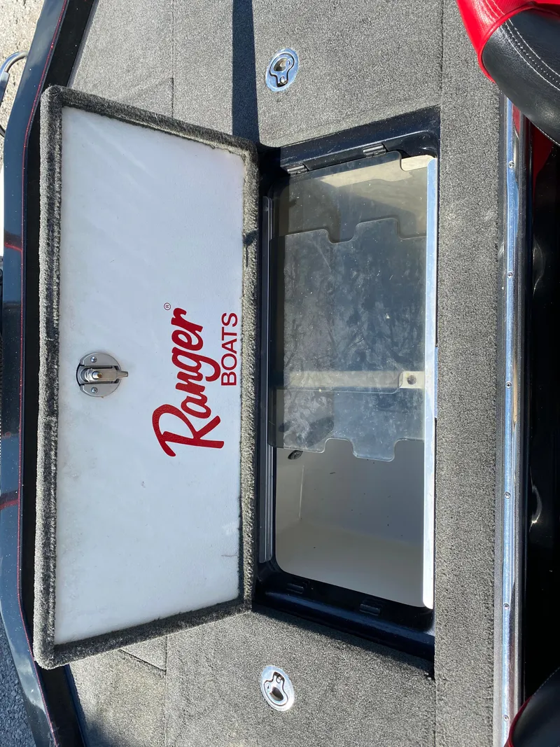 Slide: The Image of 2017 Ranger Z520C Comanche boat storage compartment with open lid, showing interior space. - 21