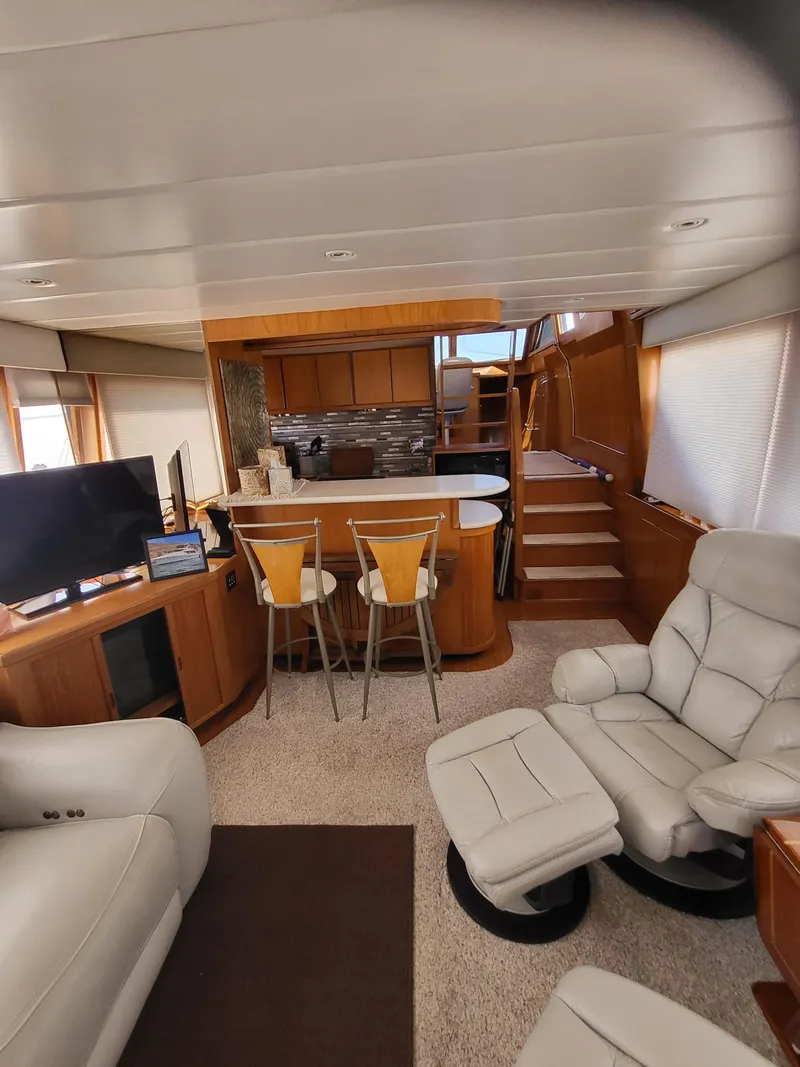 Slide: The Image of Luxurious interior of a 1997 McKinna 48' Pilot House with modern furnishings and cozy seating. - 10