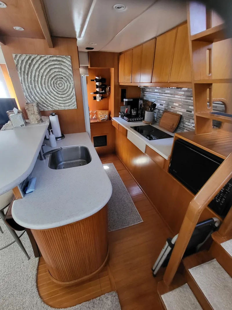 Slide: The Image of Luxurious kitchen in a 1997 McKinna 48' Pilot House yacht with modern amenities. - 11