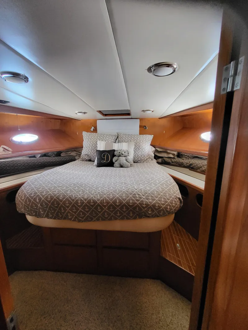 Slide: The Image of Cozy bedroom in 1997 McKinna 48' Pilot House yacht with elegant bedding and wood accents. - 13
