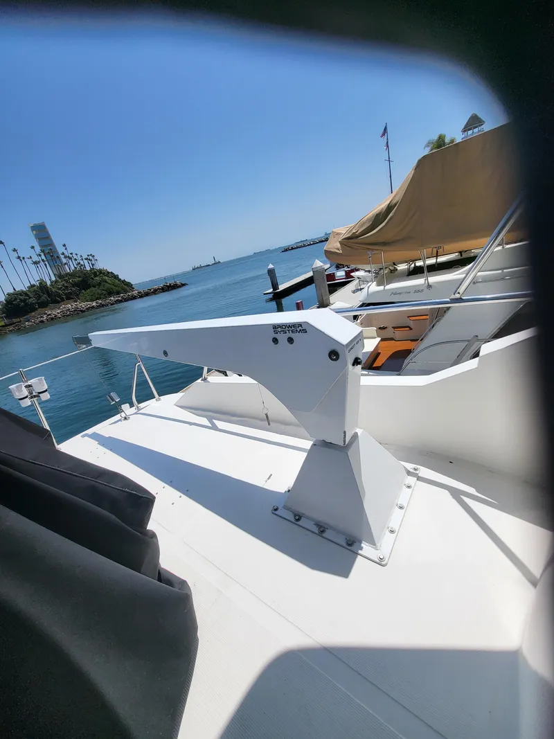 Slide: The Image of 1997 McKinna 48' Pilot House yacht docked by a scenic waterfront. - 21