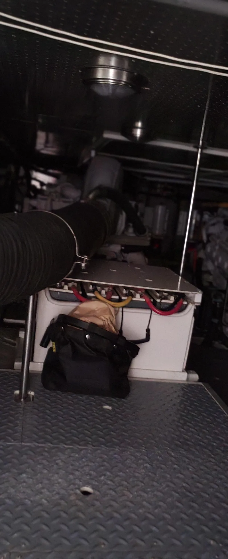 Slide: The Image of Engine room of a 1997 McKinna 48' Pilot House with visible equipment and wiring. - 23