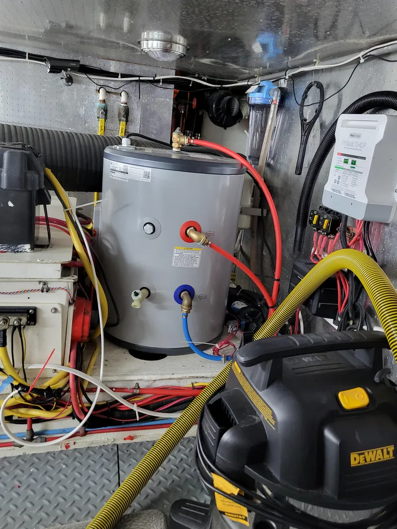 Slide: The Image of Engine room of 1997 McKinna 48' Pilot House with water heater and wiring. - 27